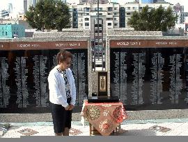Family member prays before monument for Japanese-Americans war d